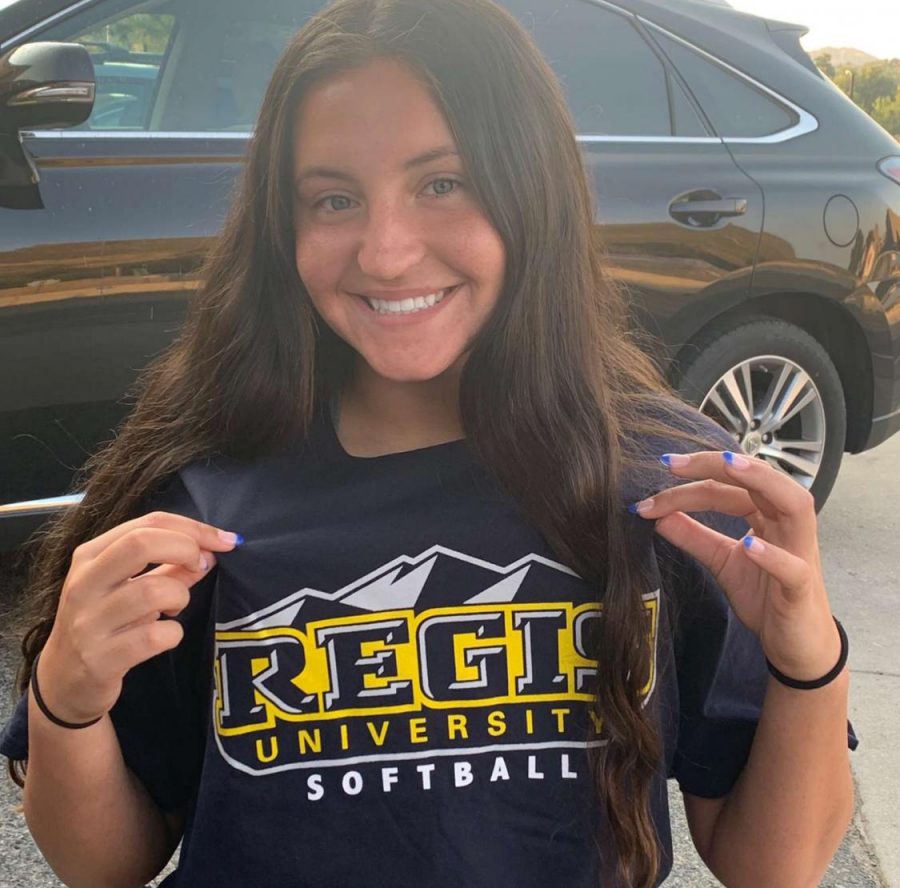 Wick smiles with her Regis t-shirt on, her new university she will attend to play softball. 