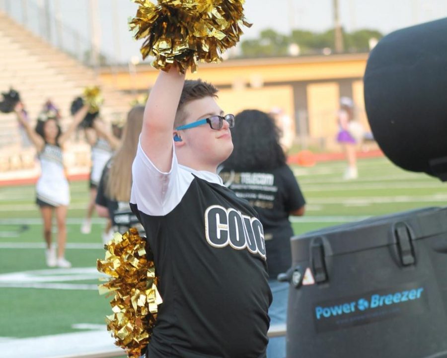 Jackson holds his pom poms high in the air at the homecoming game Sept. 10. 