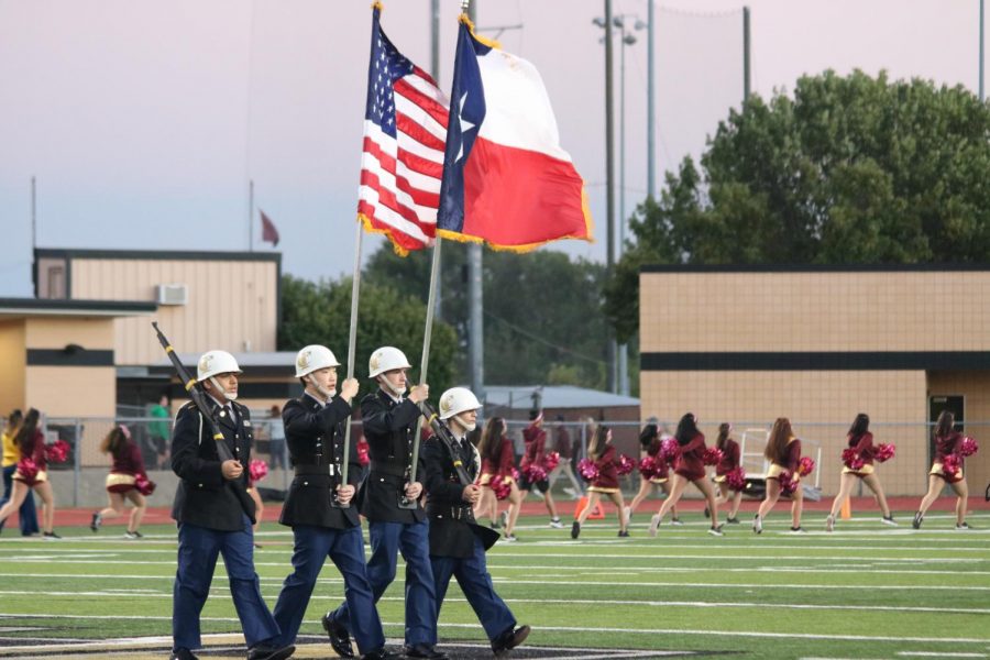 JROTC officer march with the flags at the game against Heritage. 