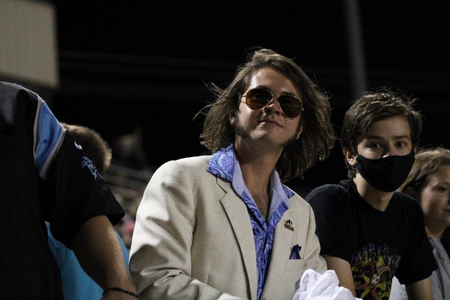 Chase Meyer (11) attends the first home game of the year in his usual suit and glasses attire.
