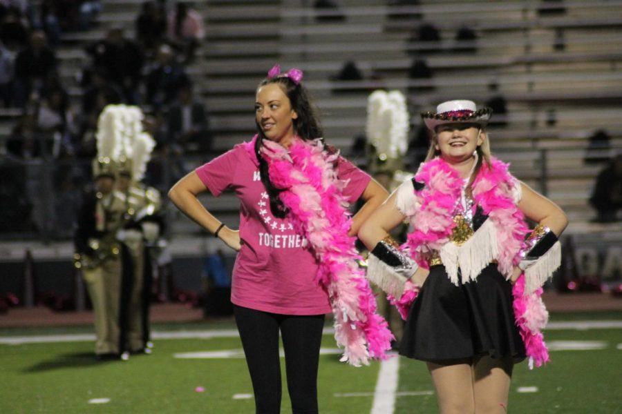 Topcat Grace Talley (11) and cheer coach and science teacher Morgan Elledge dance together at the Pink Out game.  