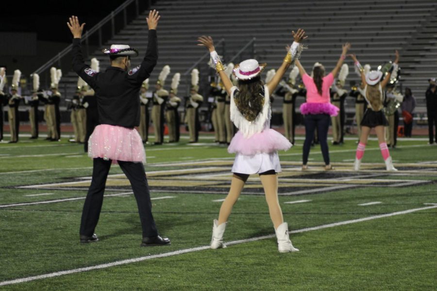 Christina Delacruz (12) dances with Students Resource Officer Omar Montemayor at the Pink Out game against Heritage. 