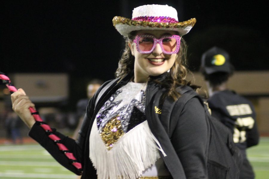 Topcats Officer Mia Whisonant (12) smiles with pink glasses at the game. 
