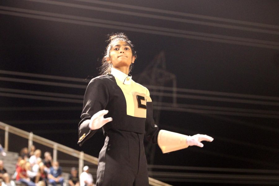 Anchal Amin conducts the band as drum major at the Sept. 24 football game at Tommy Briggs stadium.