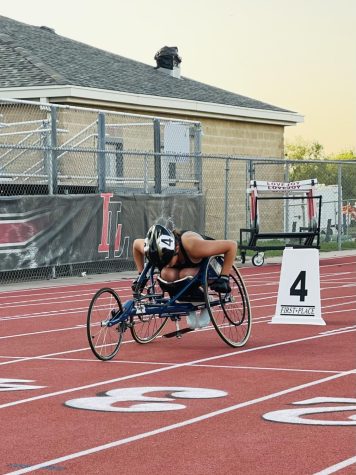 Olivia Molnar (11) races in the 100m wheelchair race at the district meet April 15.
